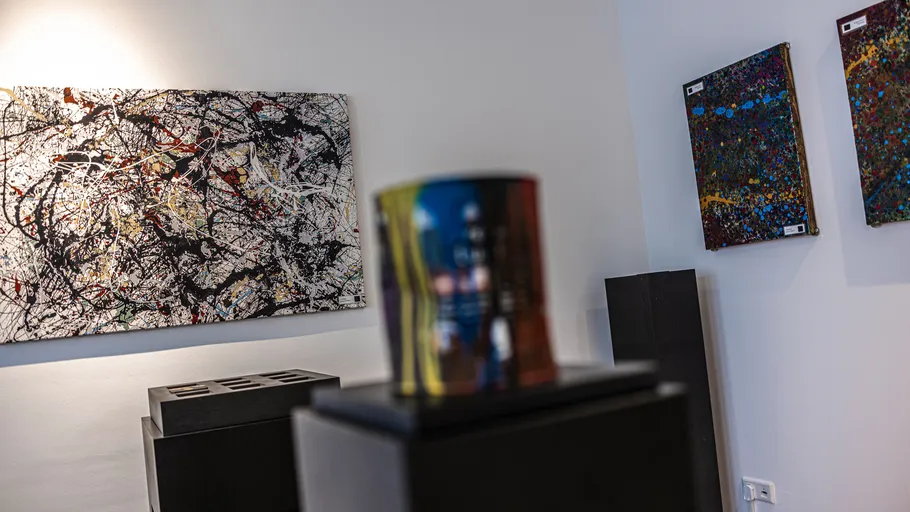 Abstract paintings displayed in a gallery.