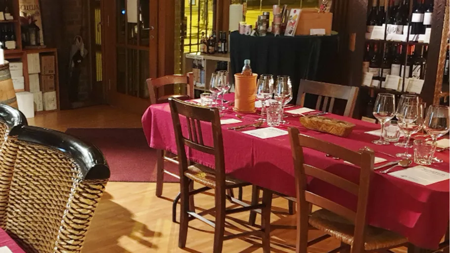 Table with red cloth in cozy restaurant.