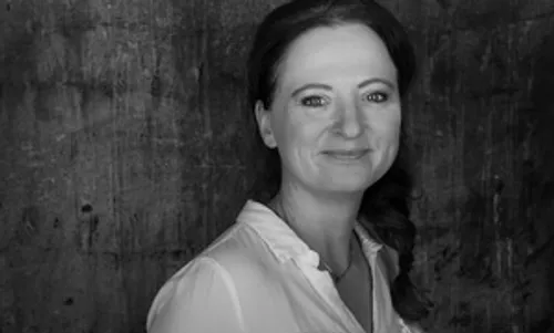Smiling woman with dark background portrait.