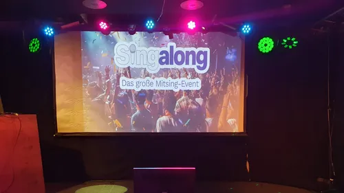 Stage with a Singalong event banner displayed.