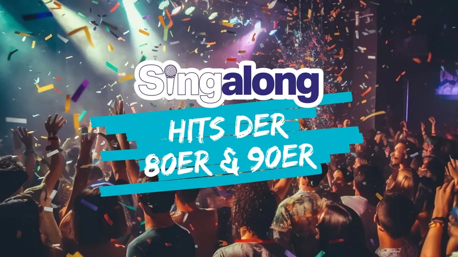 Menschenmenge feiert bei Konzert mit Konfetti.