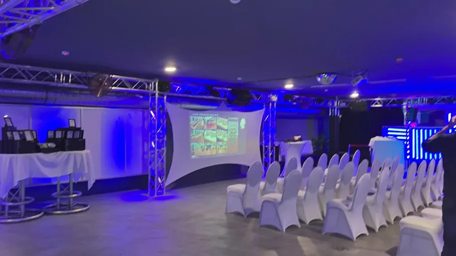 Chairs facing a screen in a dimly lit room.