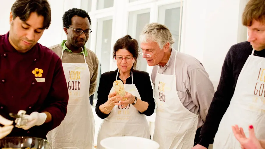 Group cooking lesson in a bright kitchen.