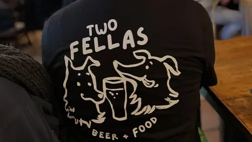 Shirt with cartoon dogs and beer graphic.