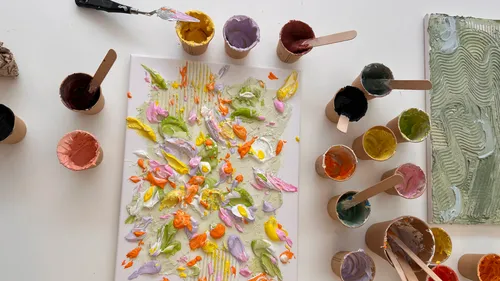 Colorful paint palette with mixed paints on canvas.
