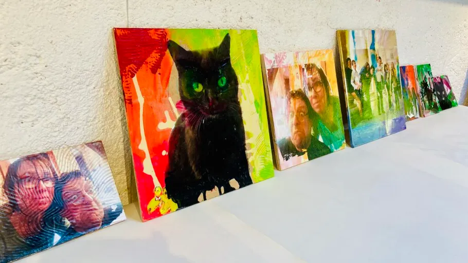 Colorful photo canvases leaning on wall.