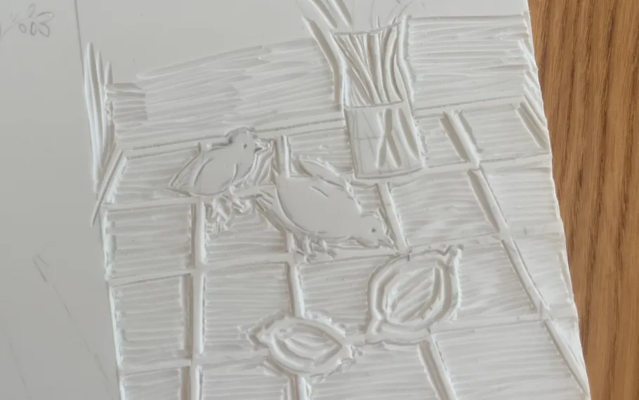 Carved birds and flowers on white surface.