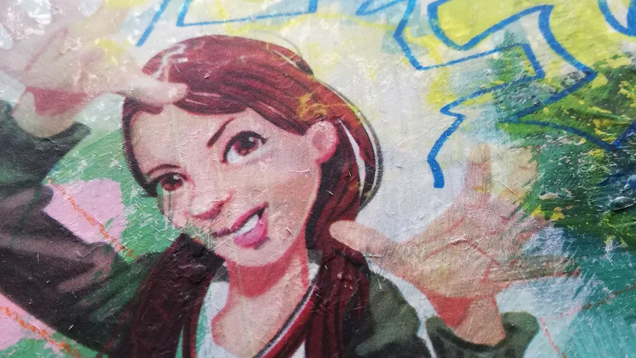 Colorful graffiti of a girl playfully posing.