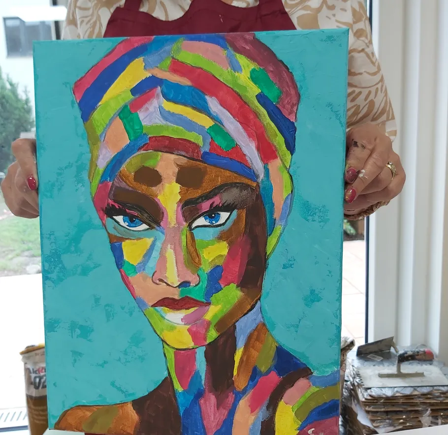 Colorful portrait held by person indoors.