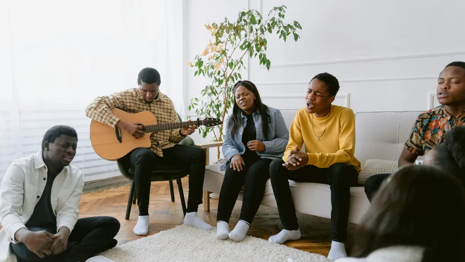 Group singing together in a living room.