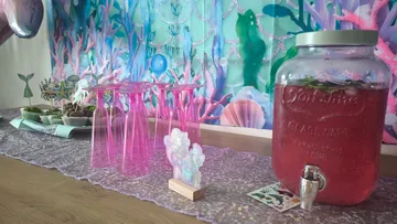 Mermaid-themed table setup with pink glasses.