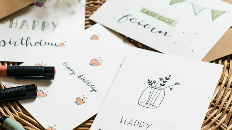 Various greeting cards on a wicker basket.
