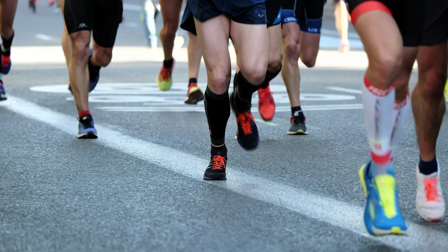 Runners racing on a city street.