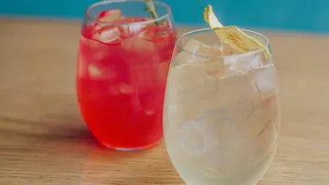 Two cocktails on a wooden table.