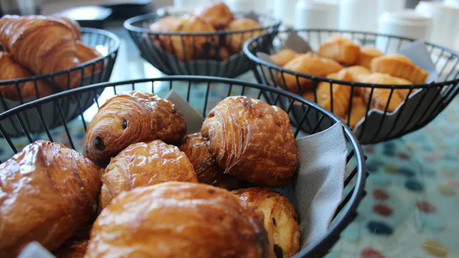Pastries in wire baskets on a table.
