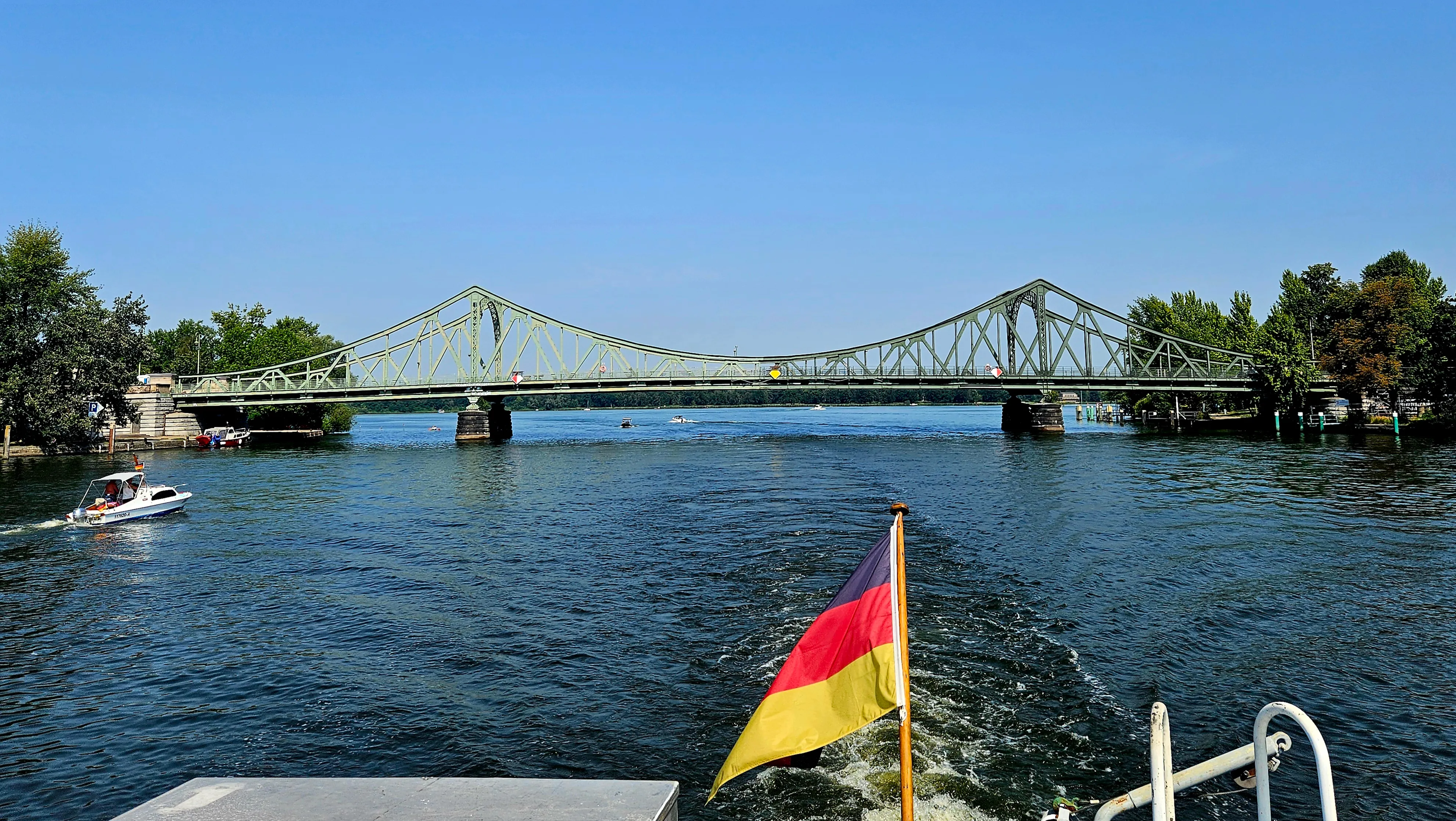 Bridge over water with a German flag.