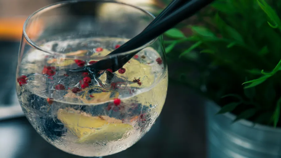 Cocktail with ice and spices in glass.