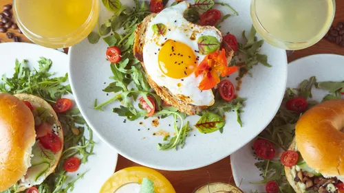 Egg on toast surrounded by bagels.