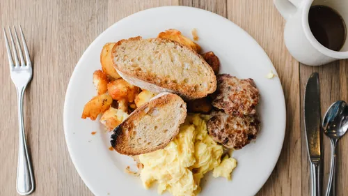 Plate with breakfast food on a table.