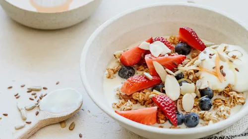 Granola bowl with fruit on table.