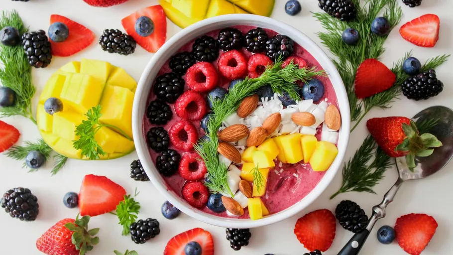 Colorful smoothie bowl with assorted fruits.