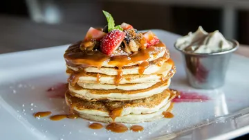 Pancakes with syrup and fruit topping.