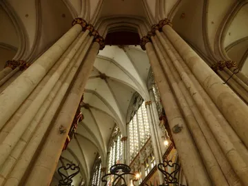 Columns stand, a Gothic church, high ceiling and windows.