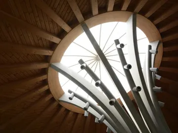 Round window at the top, pillars strive for light.