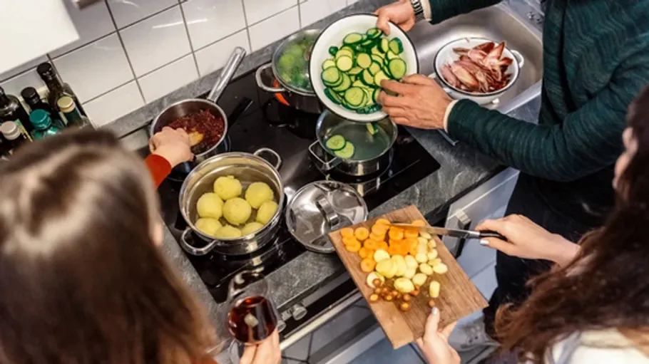 People cooking together in a kitchen.