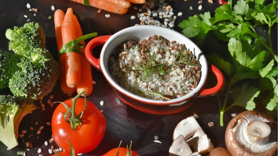 Vegetables and grains in a bowl on a table.