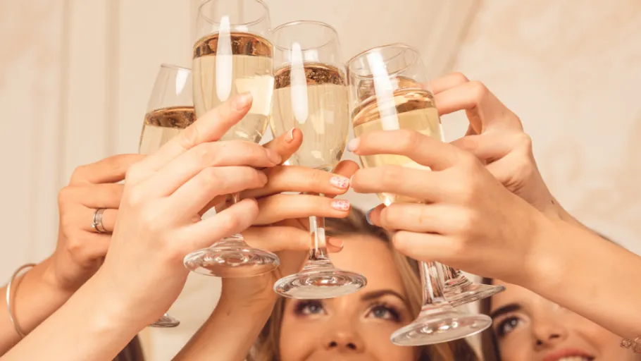 Hands raising champagne glasses in celebration.
