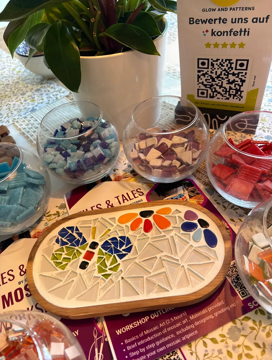 Mosaic tiles and plant on table.