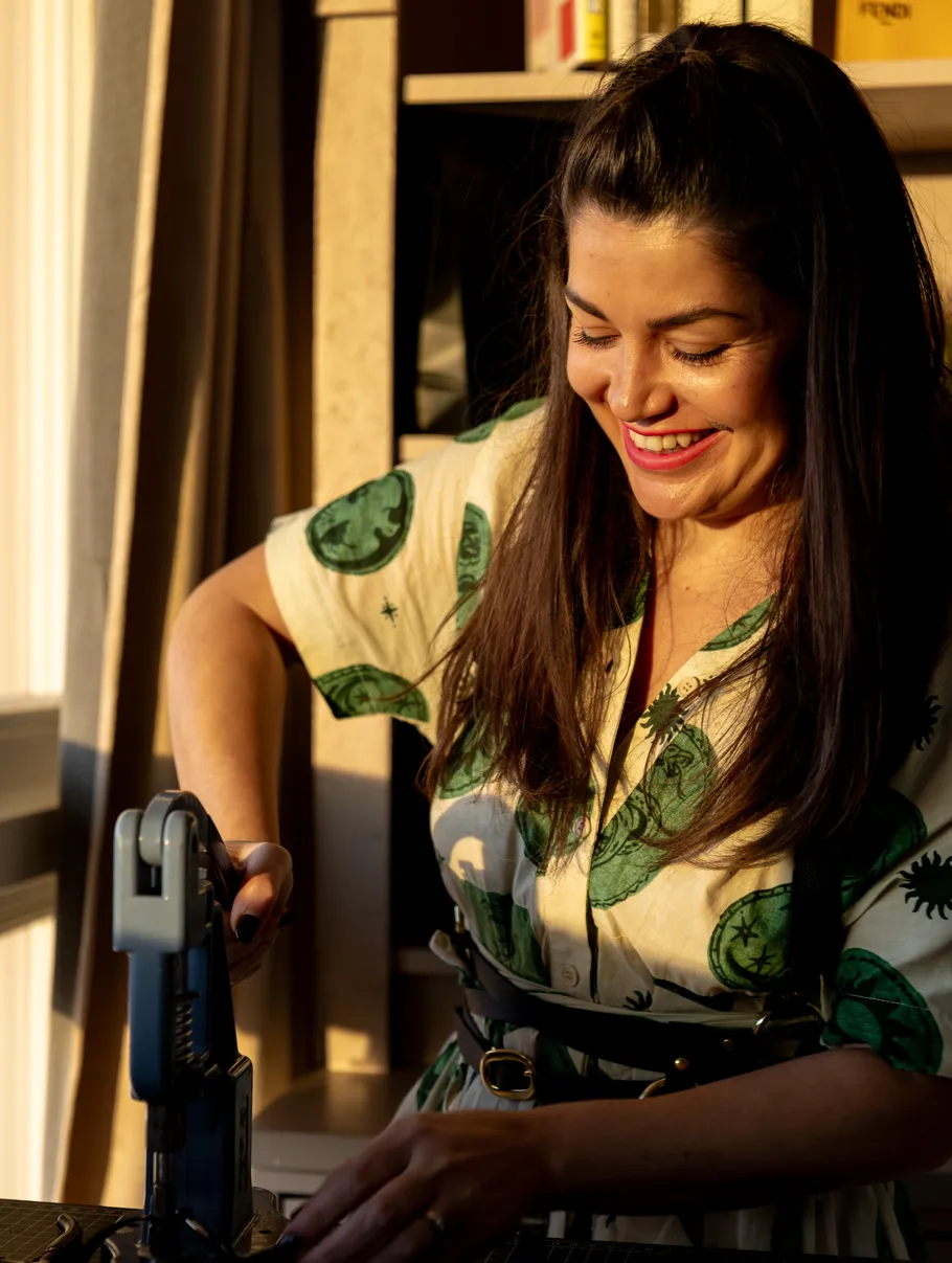 Woman smiling, using a machine, indoors.