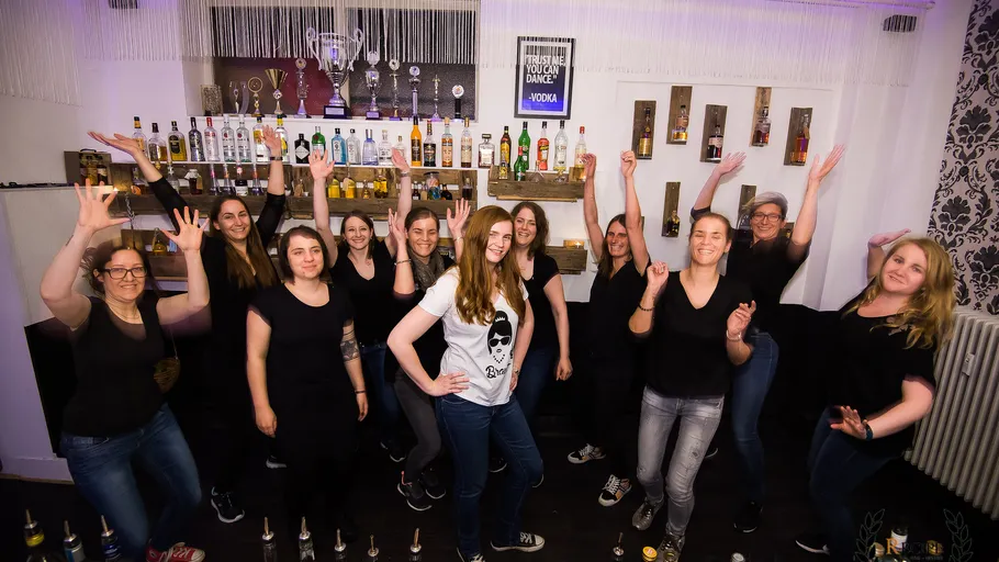 Group of women dancing in a bar.