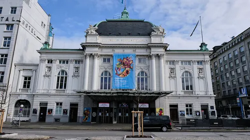 Historic theater building with banner and columns.