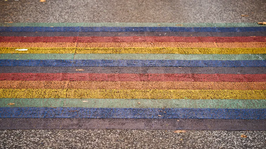 Colorful striped crosswalk on a street.