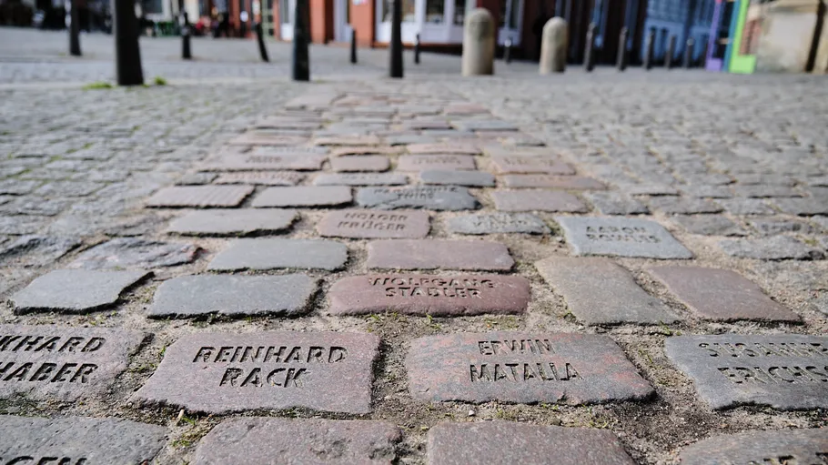 Cobblestones with names in a street setting.