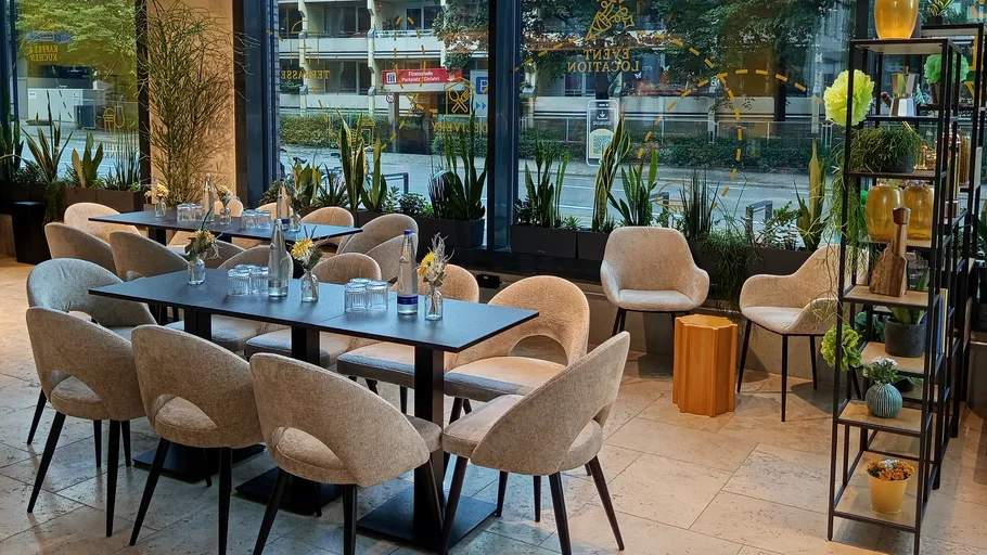 Modern restaurant interior with large windows.