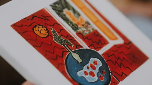 Abstract painting with red, orange, and blue shapes.