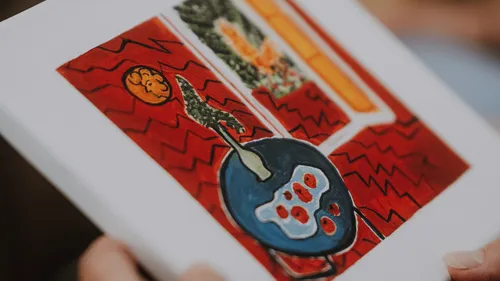 Colorful abstract painting held by hand.
