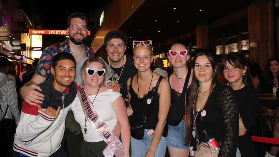 Group of people posing at nighttime street.