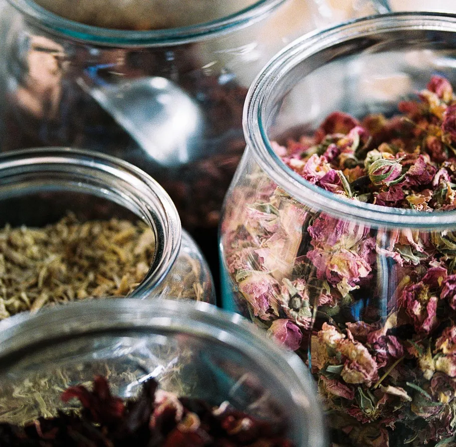 Glass jars filled with dried herbs.