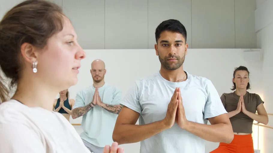 Group practicing yoga in a studio.