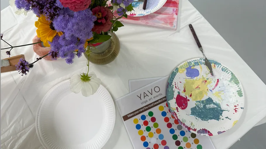 Flowers and paint supplies on a table.