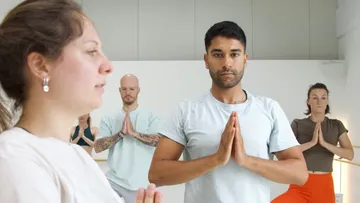 Group practicing yoga in a studio.