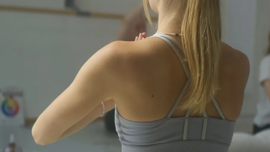 Woman in yoga pose, studio background.