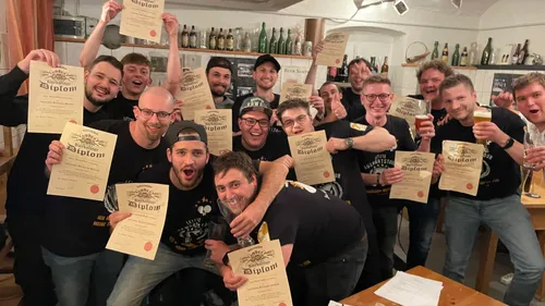 Group of men holding diplomas in celebration.