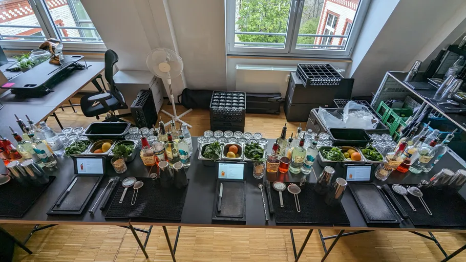 Bar setup with bottles, glasses, and ingredients.