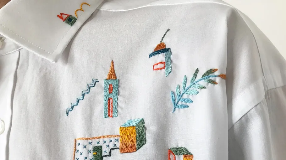 Shirt with colorful geometric embroidery design.