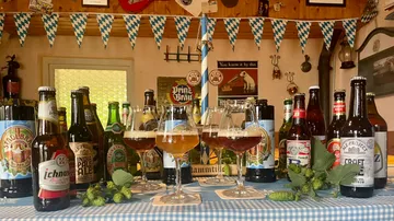 Various beer bottles on a decorated table.
